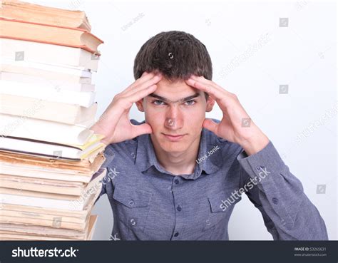 Portrait Of Young Dejected Man Sitting Behind Desk Stock Photo 53265631