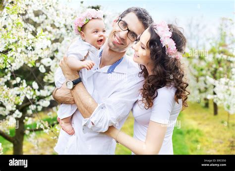 Proud Parents Hugging Their Little Baby Stock Photo Alamy