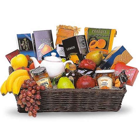 An assortment of seasonal fruits accented with a growing plant. Gourmet Tea Gift Basket at Send Flowers