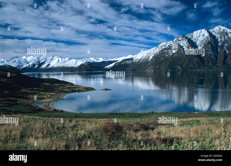 Snow Capped Mountains Reflect In Lake Wanaka On The South Island Of