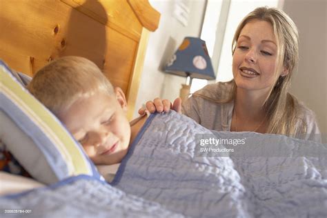 Mother Waking Up Son Sleeping In Bed High Res Stock Photo Getty Images
