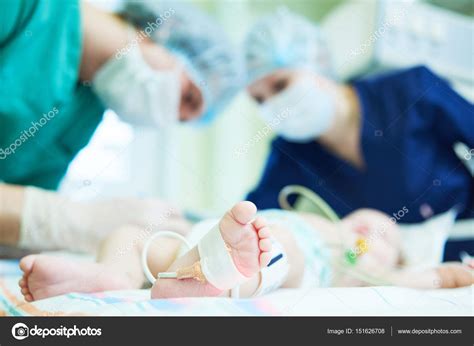Neonatal Resuscitation Doctors Team Doing Intensive Therapy To Newborn