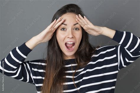 Surprise And Success Concept Amazed 20s Woman Putting Both Hands On