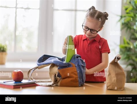Happy Child Preparing For School Little Girl Is Putting Things Into
