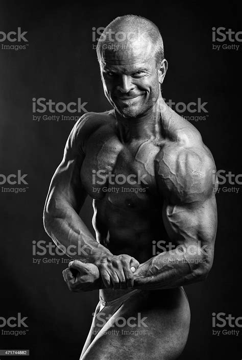 The Muscular Male Bodybuilder Flexing Biceps Stock Photo Download
