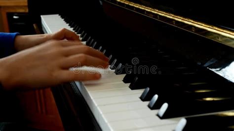 Child Playing Piano Close Up Side View Of Young Hands And Fingers