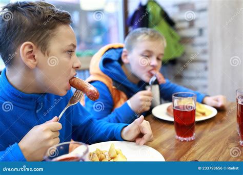Two Children Eating Sausages Stock Photo Image Of Lunch Caucasian