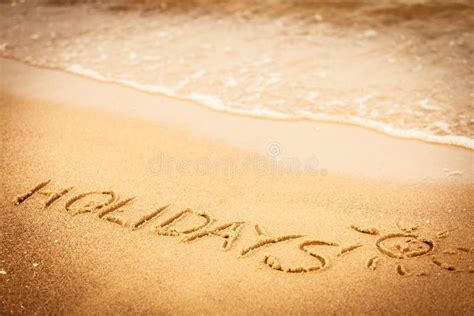 The Word Holidays Written In The Sand On A Beach Stock Photo Image Of