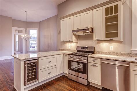 A large kitchen island with cooktop provides extra space for meal preparation and the wood surfaces provide a lovely contrast to the white cabinetry. White Shaker Cabinets - Kitchen Photo Gallery