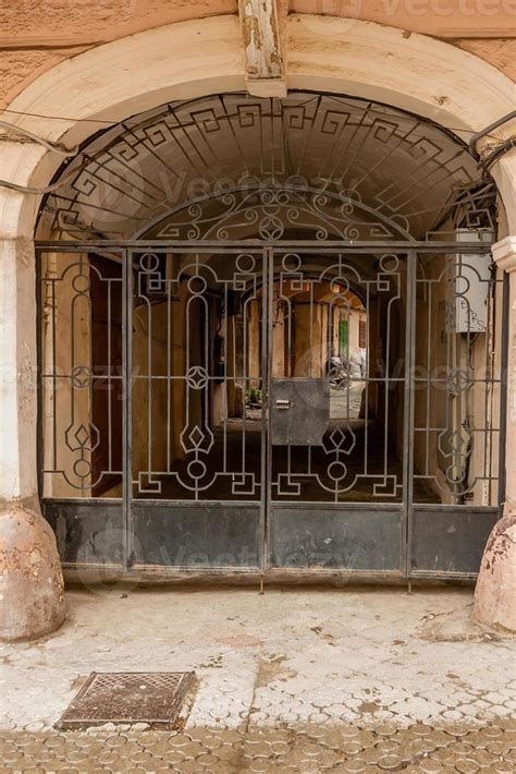 An Old Gate With A Corridor Leading To The Courtyard Of The House