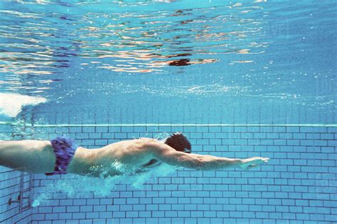 Man Swimming Underwater Side View Stock Photo Dissolve