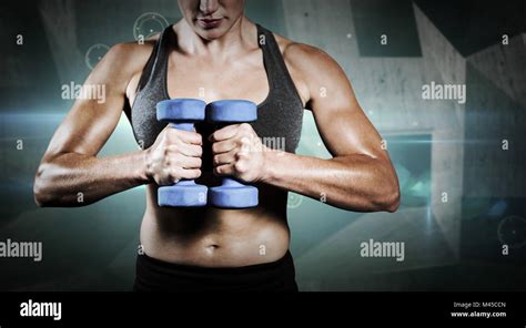 Composite Image Of Muscular Woman Lifting Heavy Dumbbells Stock Photo