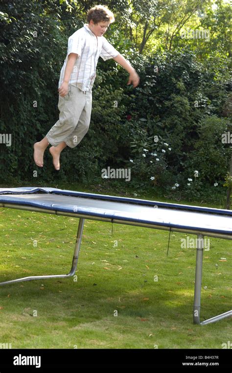 Boy Jumping On Trampoline Stock Photo Alamy