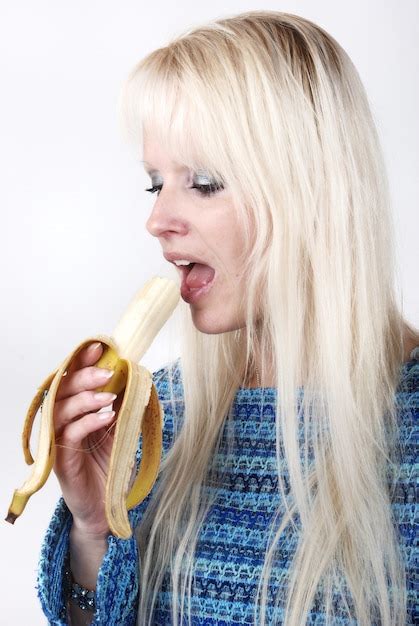 Premium Photo Blonde Woman Eating A Banana