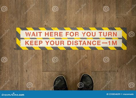 Wait Your Turn Keep Your Distance Sign On A Store Floor Stock Image