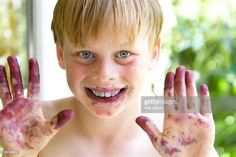Boy With Blueberry Stained Hands And Face High Res Stock Photo Getty