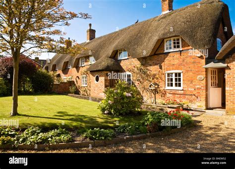 Typical Pretty English Thatched Country Cottage Or House In The Village