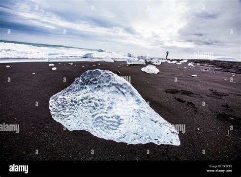 View Of Chunks Of Icebergs And Ocean Surf On The Black Sand Beach In