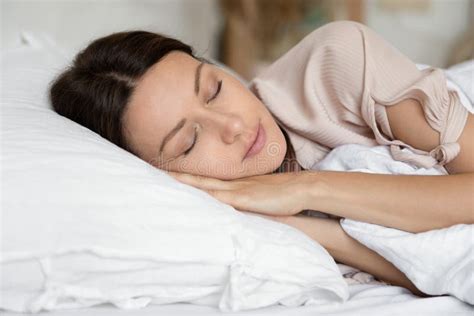 Calm Young Woman Sleep Peacefully In Comfortable Bed Stock Image
