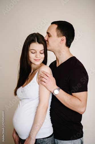 Image Of Husband Standing And Holding Belly Of Pregnant Wife Hands