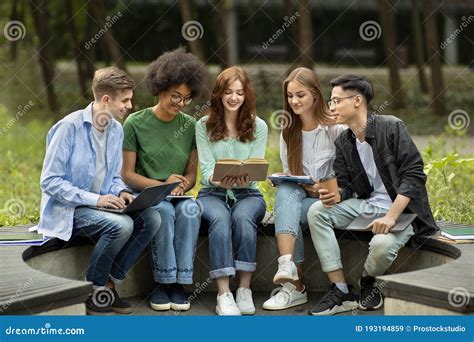 Multicultural University Students Studying Outdoors With Books And