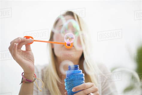 Caucasian Woman Blowing Bubbles Outdoors Stock Photo Dissolve