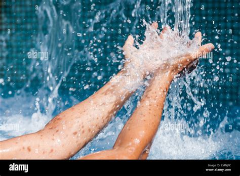 Water Pouring Into The Hands Of A Woman Stock Photo Alamy