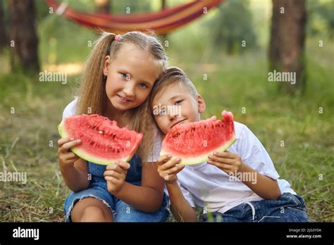 Cute Kids Eating Watermelon In The Garden Stock Photo Alamy