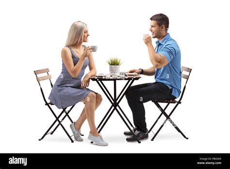 Two People Sitting At A Table