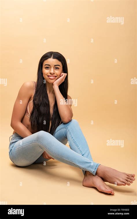 Beautiful African American Girl Sitting With Crossed Legs And Looking