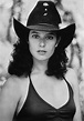 black and white photograph of a woman wearing a cowboy hat