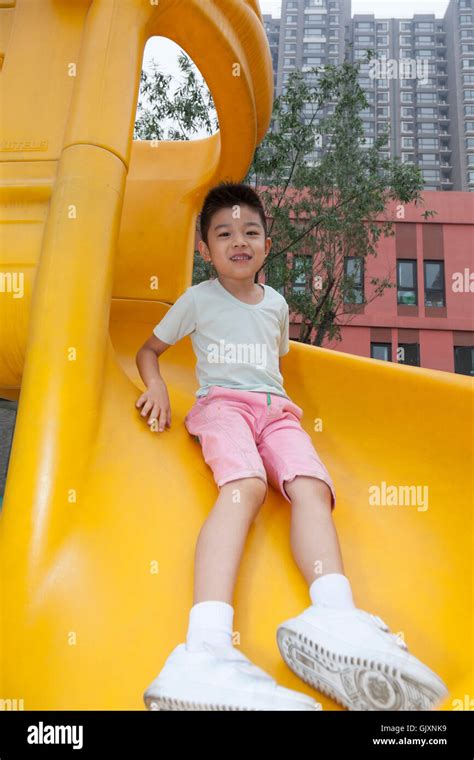 Little Boy Playing In Kindergarten Slides Stock Photo Alamy