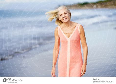 Elderly Female Enjoying Her Retirement At A Seaside Retreat Senior