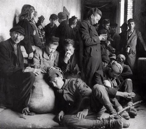 exhausted homeless german refugees huddled in a city municipal building seeking shelter war