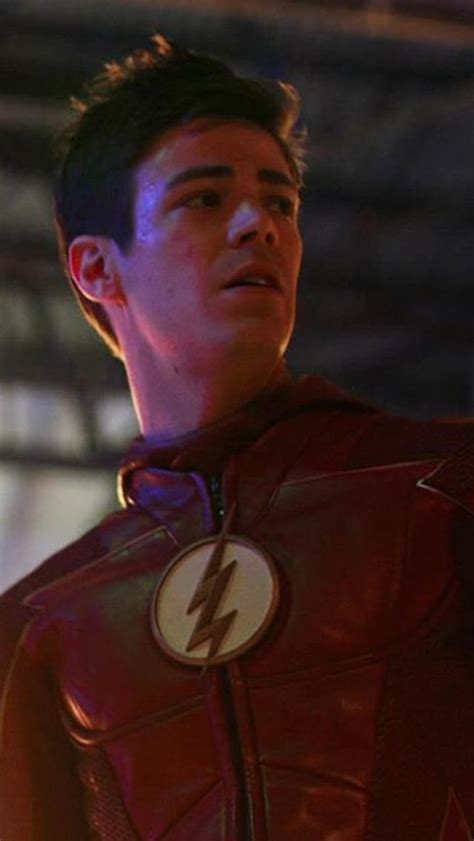 The Flash Standing In Front Of A Building With His Hand On His Hip And