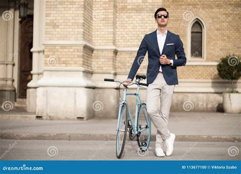 Young Businessman With Bicycle Outdoors On The Street Stock Photo