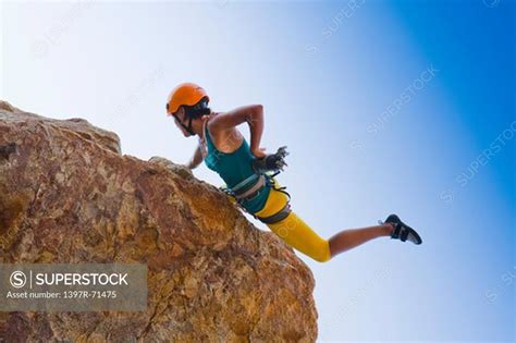 Woman Rock Climbing On Cliffs Superstock