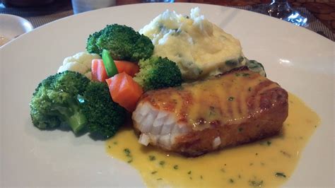 Chilean Sea Bass Smothered In A Lemon Butter Sauce With Spinach Mashed Potatoes And Assorted