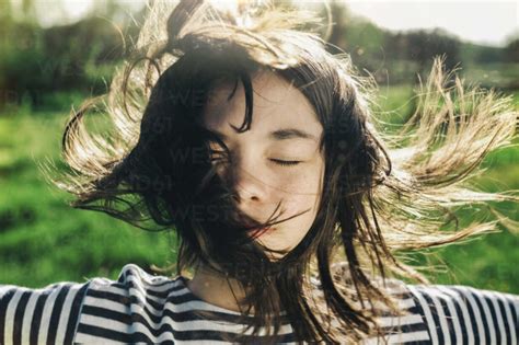 Wind Blowing Hair Of Caucasian Teenage Girl Stock Photo