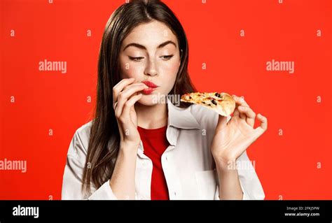 Brunette Girl Licks Fingers Amazed By Super Good Taste Of Pizza Slice