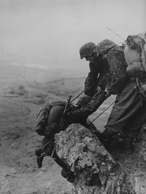 Soldiers From The Prinz Eugen Division Help Each Other In Climbing A