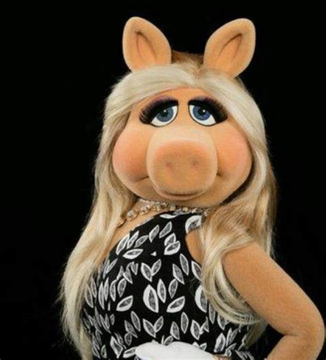 The Miss Piggy Doll Is Dressed In Black And White Dress With Long