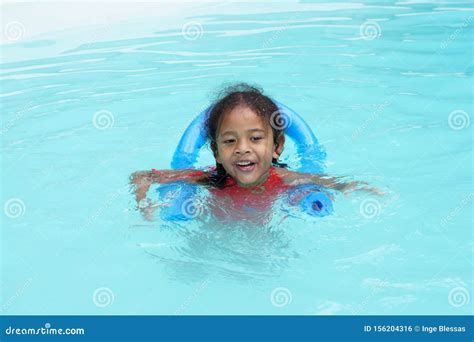 Happy Young Multiracial Girl Child Learning To Swim Stock Photo Image