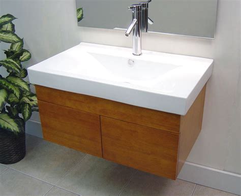 The clean, contemporary lines are enhanced by a crisp white vessel sink, high gloss white finished sides and nature wood drawer front finish. Wall Mounted Bathroom Vanities