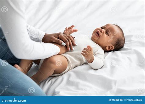 Black Mother Doing Belly Massage For Crying Infant Stock Image Image