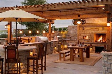 Outdoor living spaces are as varied as our homes themselves. Tuscan style outdoor kitchen, living room and bar with ...