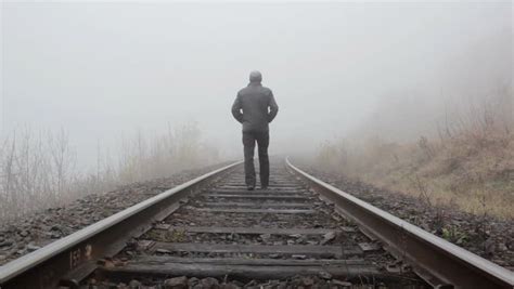 Man Alone Walking Away On The Train Rails Railroad Patagonia
