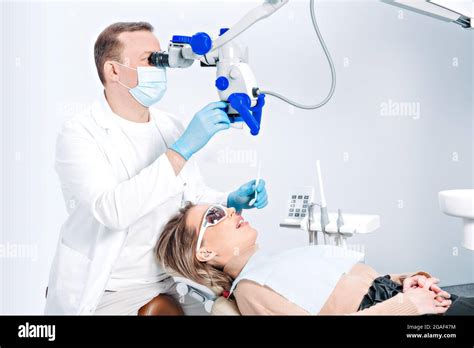 Pretty Caucasian Woman In Dentist Chair In Modern Dental Clinic Doctor