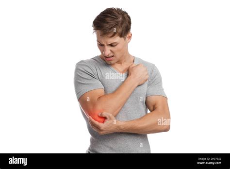 Sad Young Caucasian Guy Athlete Suffering From Elbow Pain Presses Hand