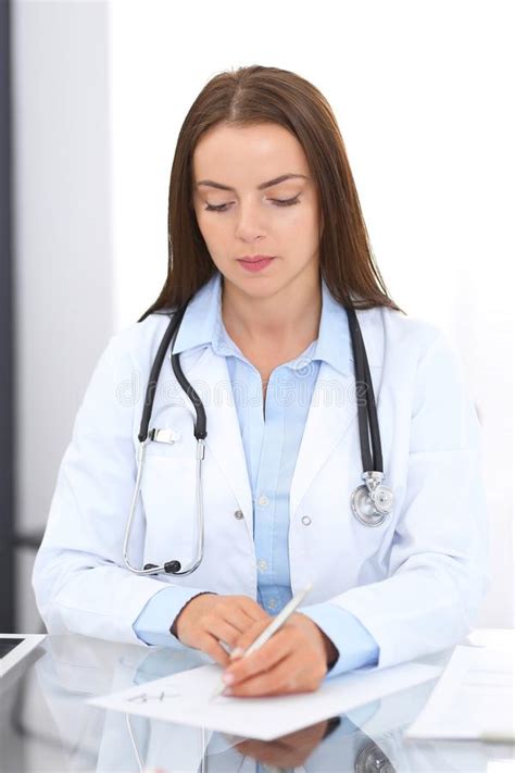 Doctor Woman At Work Portrait Of Female Physician Filling Up Medical